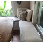 ```json { "alt_text": "Elegant rectangle window seat cushion in a cozy nook", "title": "Deluxe Window Seat Cushion - Optimal Comfort", "associated_text": "Enhance your space with our optimal comfort window seat cushion.", "description": "This image showcases a beautifully designed rectangle window seat cushion, perfectly fitted in a serene nook. The cushion features a plush, inviting appearance ideal for adding comfort and style to any room. Its soft fabric and meticulous tailoring reflect a high-quality, luxurious addition to home decor." } ```